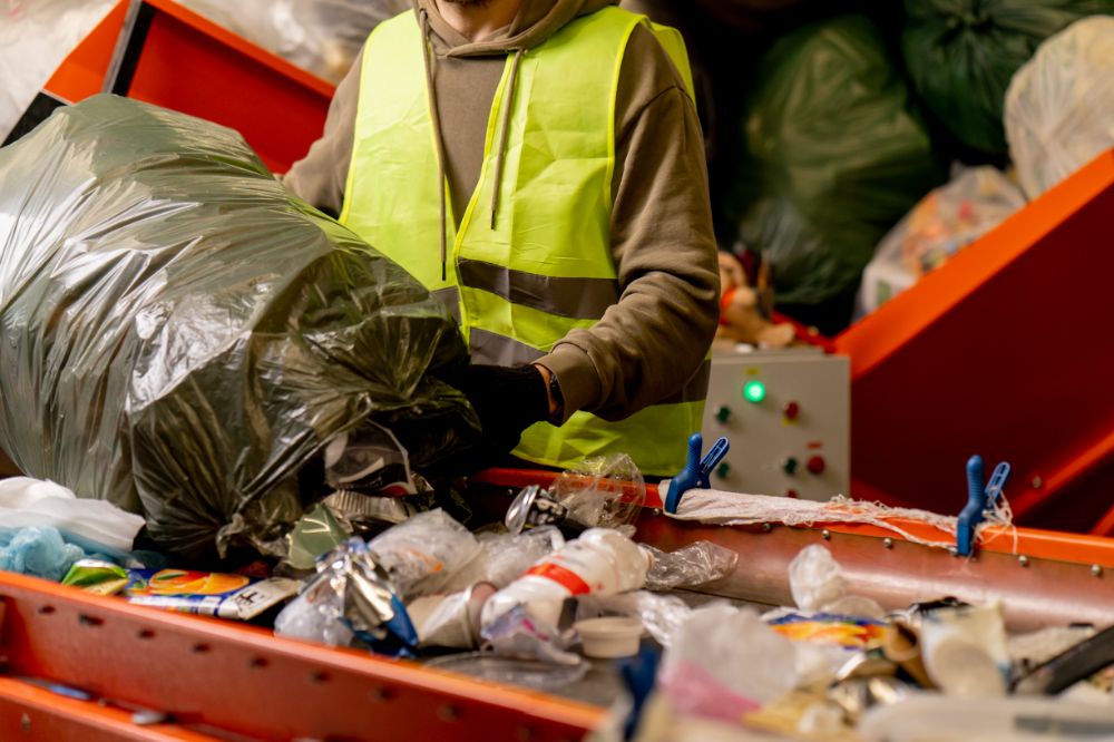 male-sorter-with-a-protective-vest-gloves-unloads-2024-01-26-17-04-54-utc 2